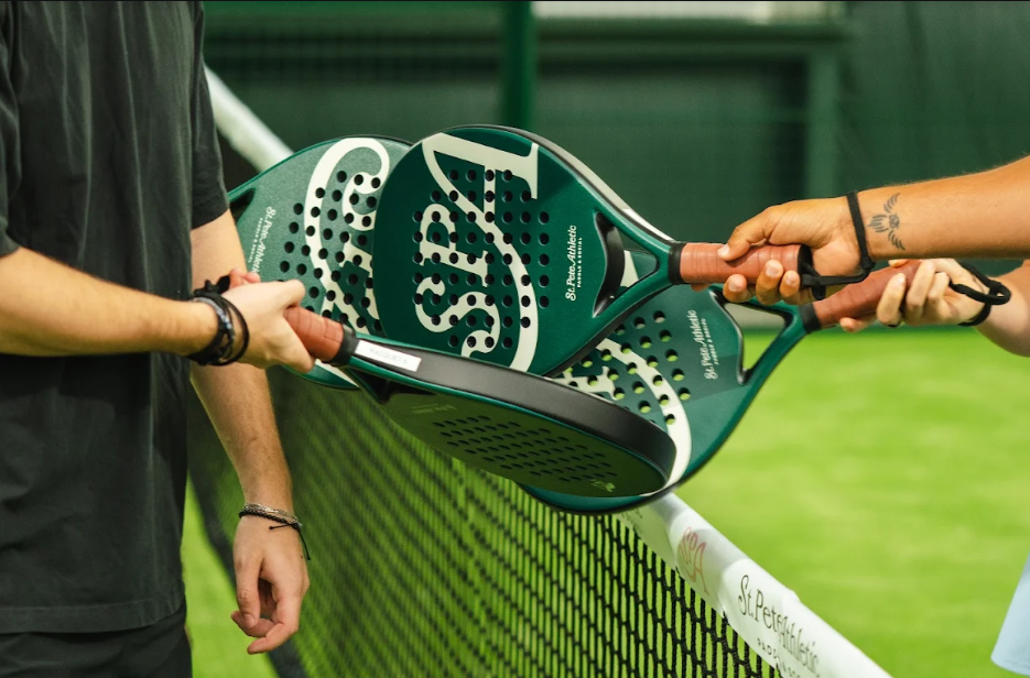 Dynamic scene of women playing padel tennis at Vibora Club in Baghdad, Iraq.